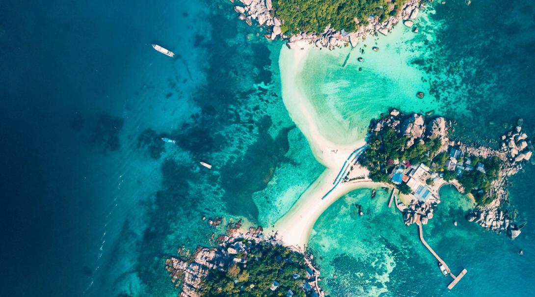 A top-down, aerial view of the tropical island of Koh Tao and its beaches.