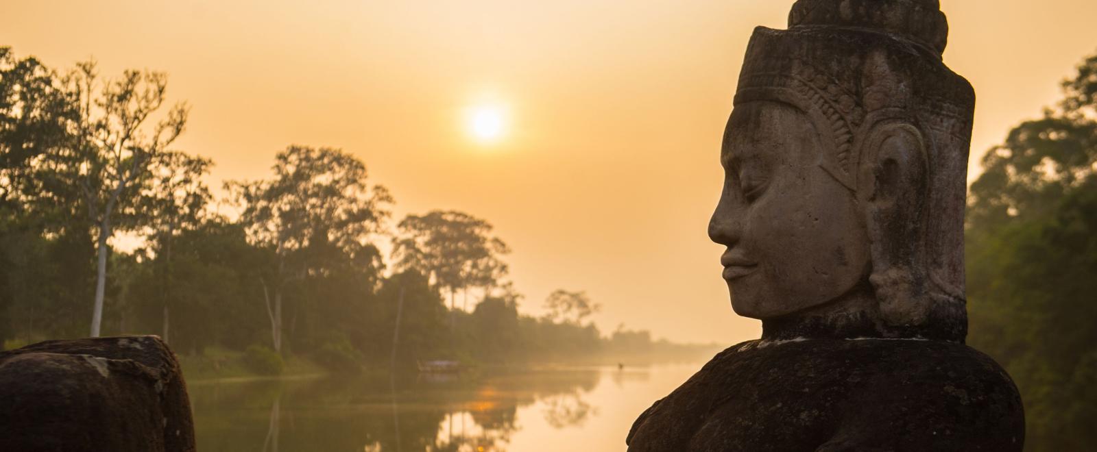 Buddha is shown over a body of water in Angkor Wat, where Projects Abroad volunteers visit and educate themselves on Khmer history.