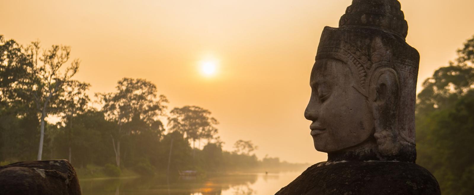 Buddha is shown over a body of water in Angkor Wat, where Projects Abroad volunteers visit and educate themselves on Khmer history.