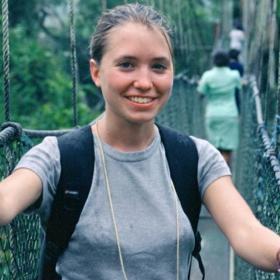 A participant looks at the camera while walking on a rope bridge in Ghana
