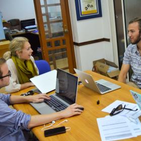 A group of Human Rights interns in Africa have a lively discussion while doing research for a case. 