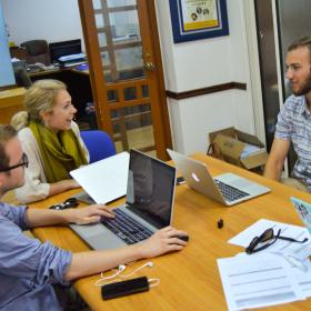 A group of Human Rights interns in Africa have a lively discussion while doing research for a case. 