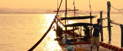 A local fisherman prepares a boat for a group of volunteers on a trip to experience Khmer cultural immersion. 