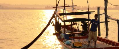 A local fisherman prepares a boat for a group of volunteers on a trip to experience Khmer cultural immersion. 