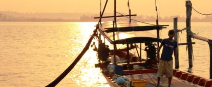 A local fisherman prepares a boat for a group of volunteers on a trip to experience Khmer cultural immersion. 