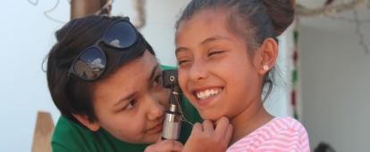 A Projects Abroad work experience intern in Mexico is seen examining a child at local doctors.