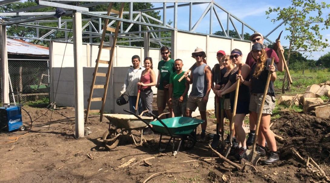 Projects Abroad volunteers work in construction during one of their group volunteer trips.