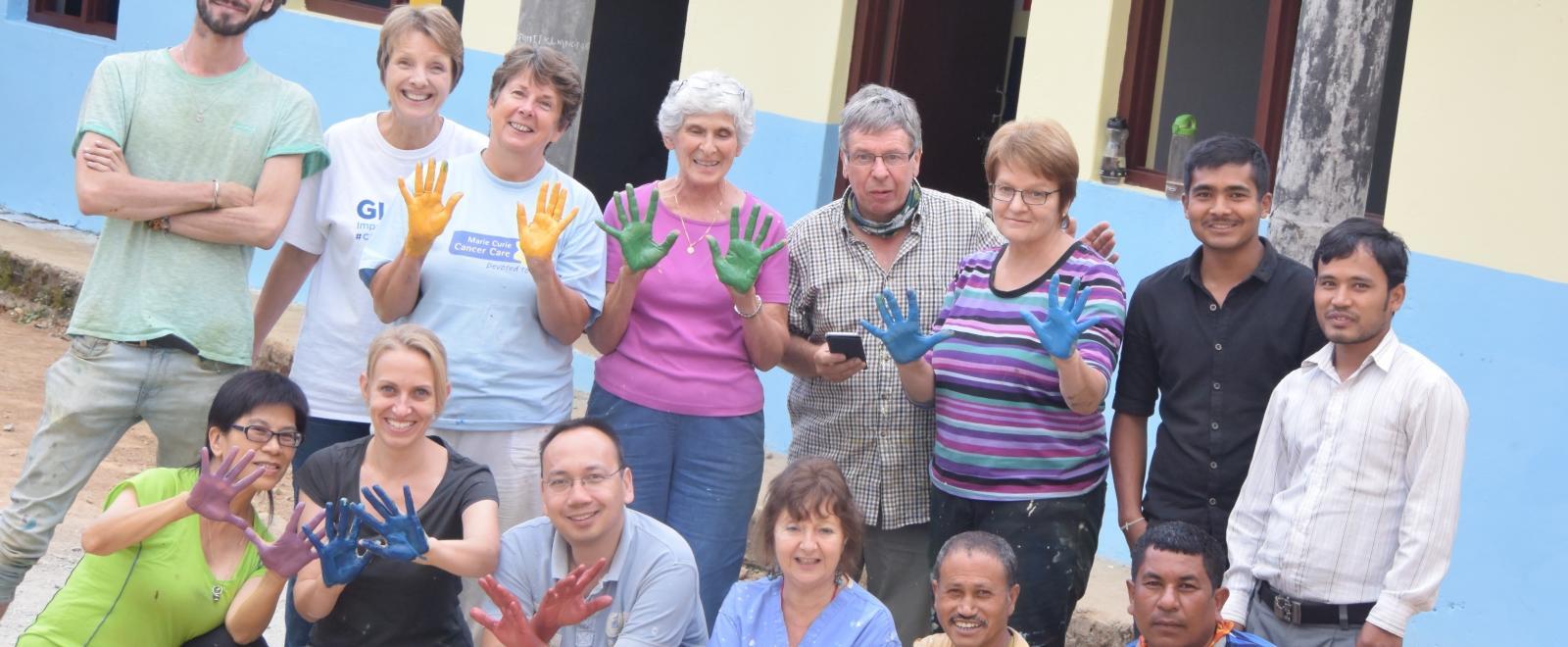 Projects Abroad Childcare volunteers completing voluntary work abroad for over 50s finish up painting work.