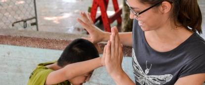 Female Intern is seen gaining valuable work experience whilst playing with a local child whilst taking part in her occupational therapy internship in Vietnam.