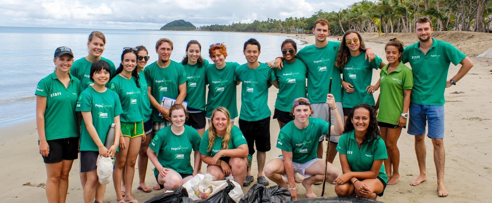 Projects Abroad volunteers pose after a successful beach clean up in Fiji.