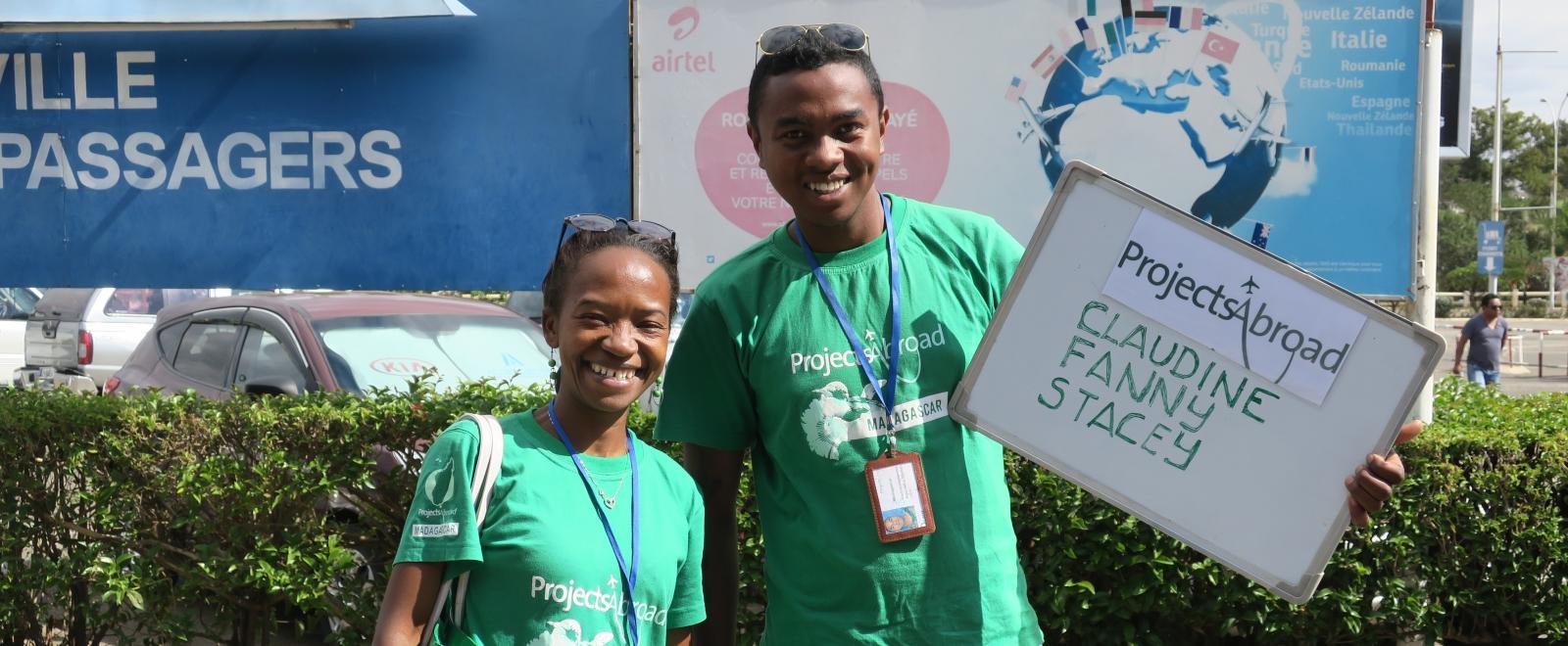 Local destination staff greet volunteers at the airport.