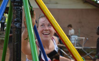 A Projects Abroad construction volunteer in Ghana painting a playground.