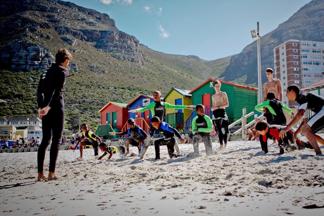 Stretching on the beach in a surfing project, South Africa
