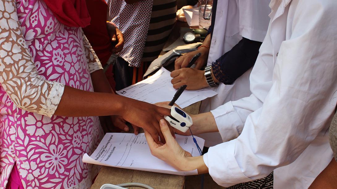 Medical interns abroad check people’s blood pressure during an outreach in Nepal