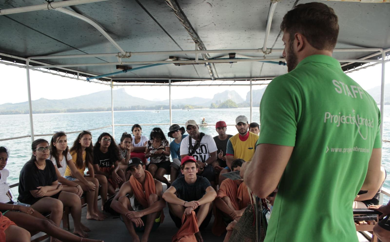Project's Abroad staff giving travelling volunteers a diving brief on responsible diving