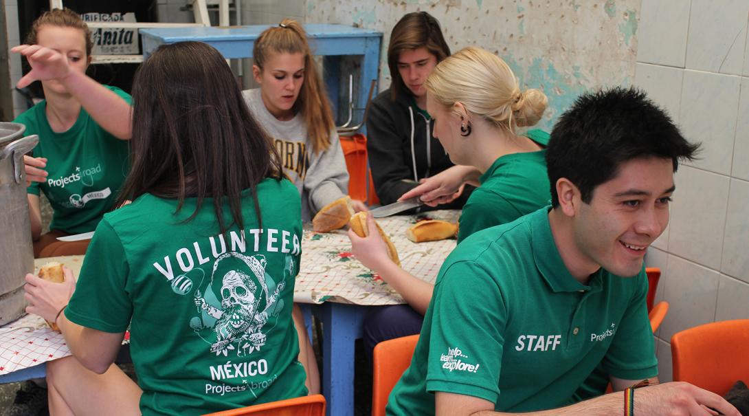 Refugee support volunteers preparing food in the camp kitchen in Mexico
