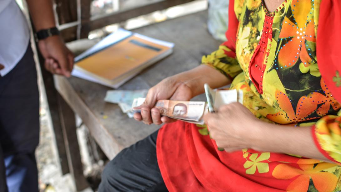 Micro-finance beneficiary pays back her loan in Cambodia.