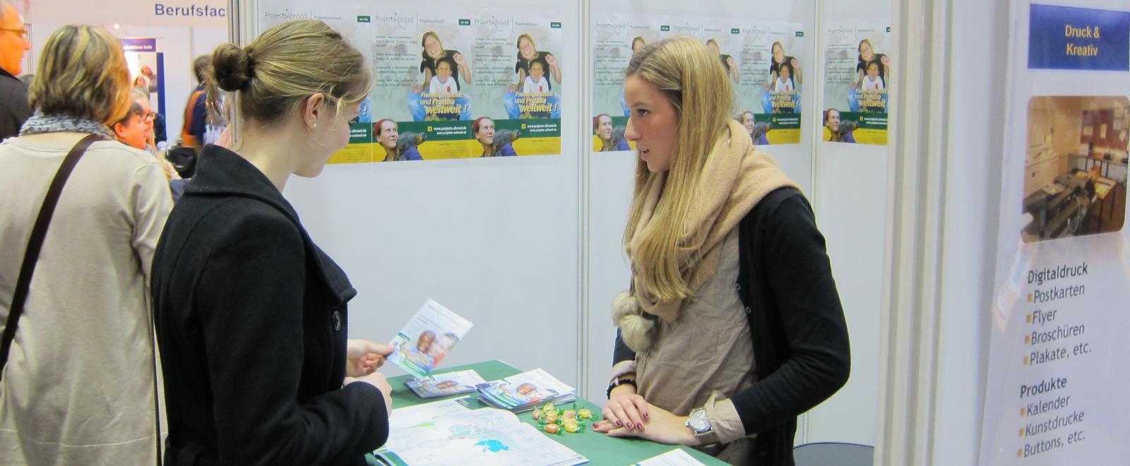 A Projects Abroad staff member chats to a career fair attendant about volunteering abroad.