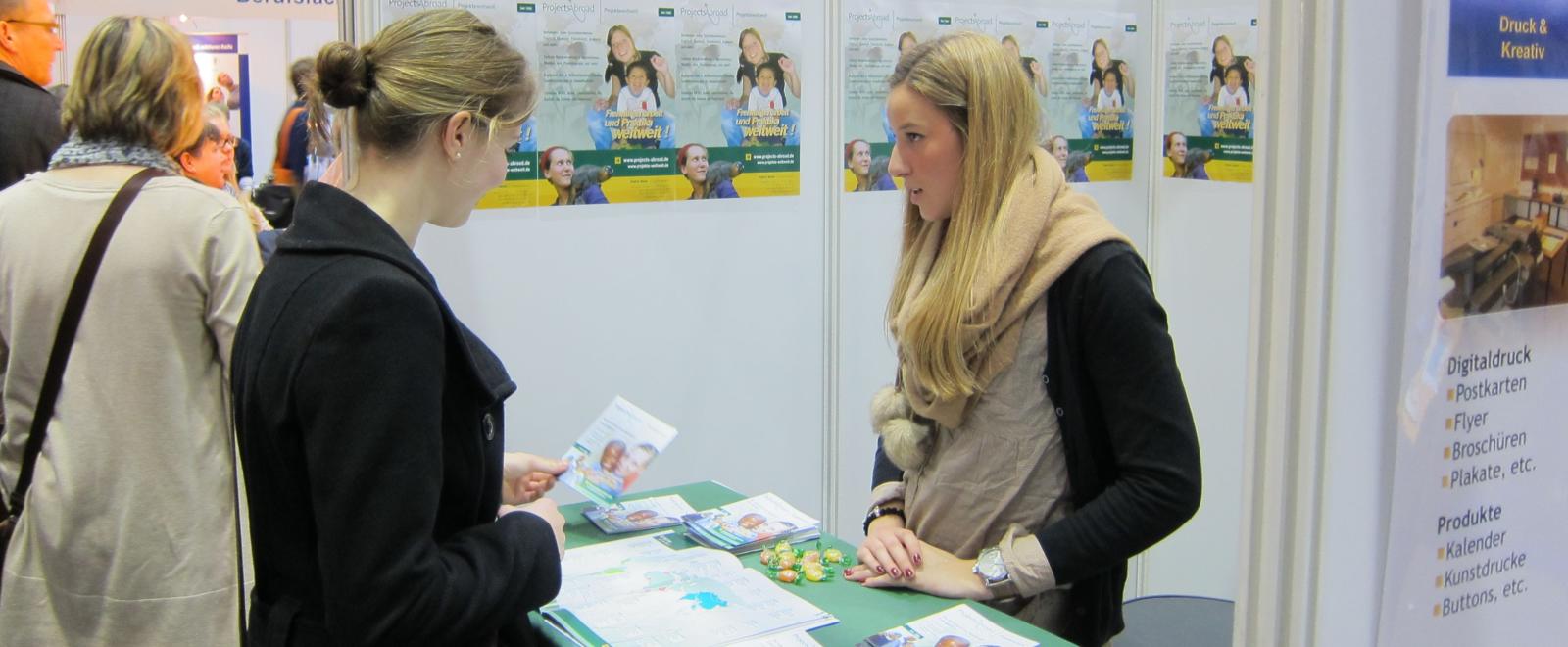 A Projects Abroad staff member chats to a career fair attendant about volunteering abroad.