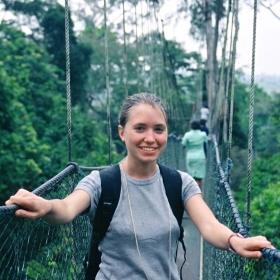 A participant looks at the camera while walking on a rope bridge in Ghana