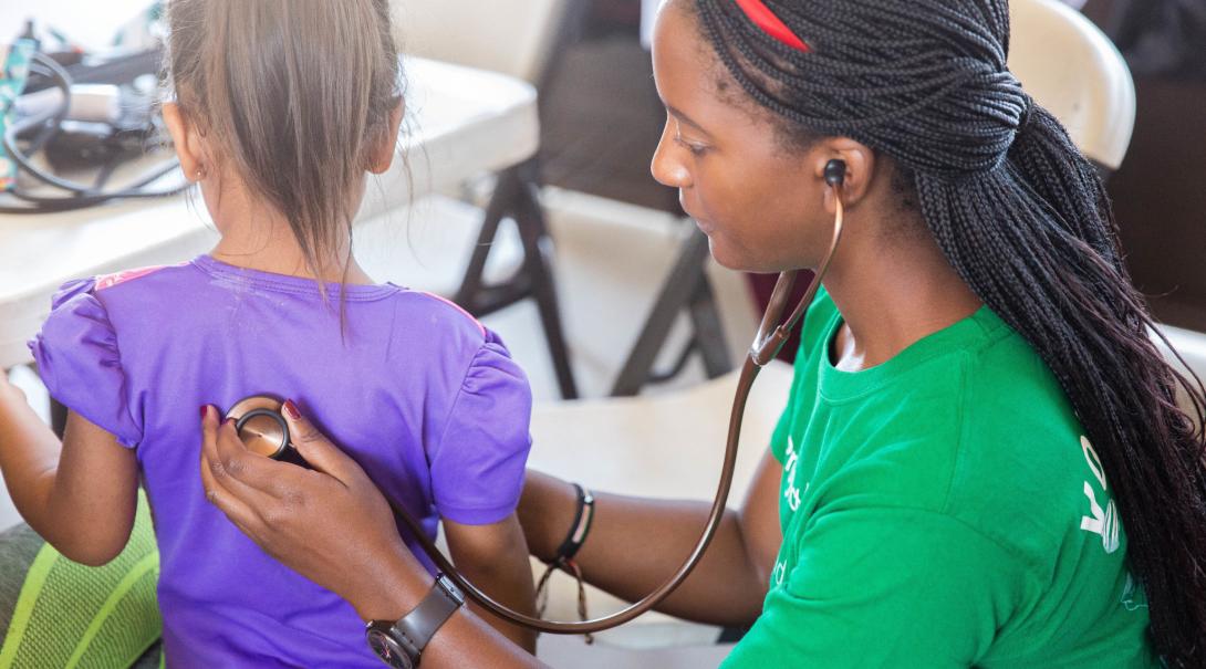 On a volunteering abroad project for university students in Mexico, a child's heart rate is checked. 