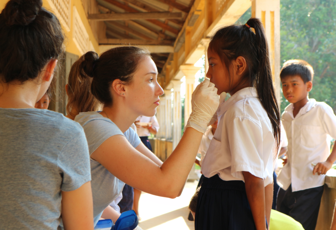 Volunteers doing health checks at a school